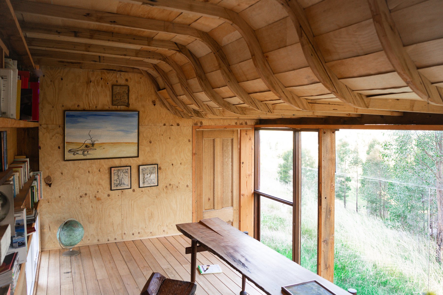 Metal-clad library cabin in regenerating eucalypt bushland, Sarsfield